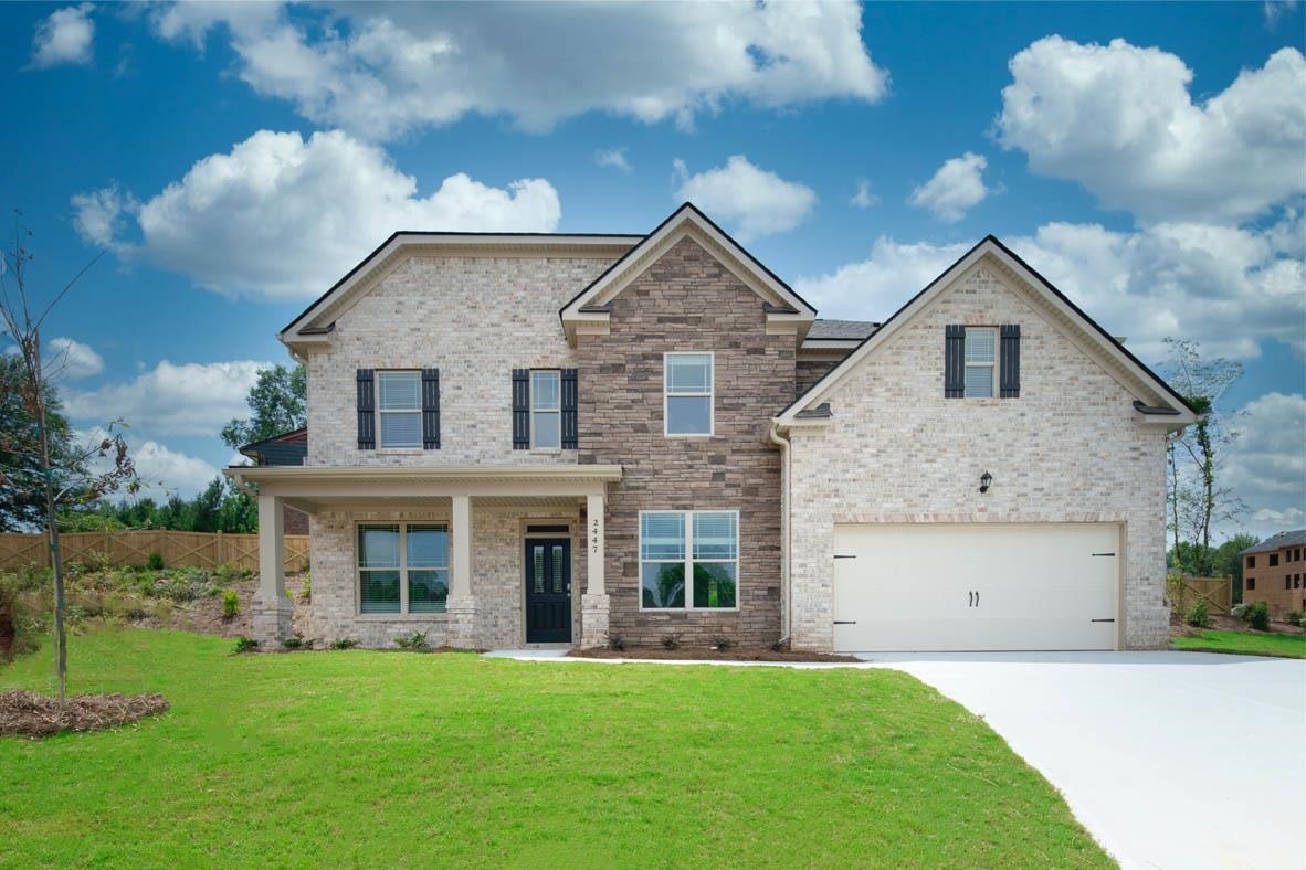 423 Beachview Road, Unit 39 Hampton, GA 30228 - Photo 1 of 1 a front view of a house with a yard and garage