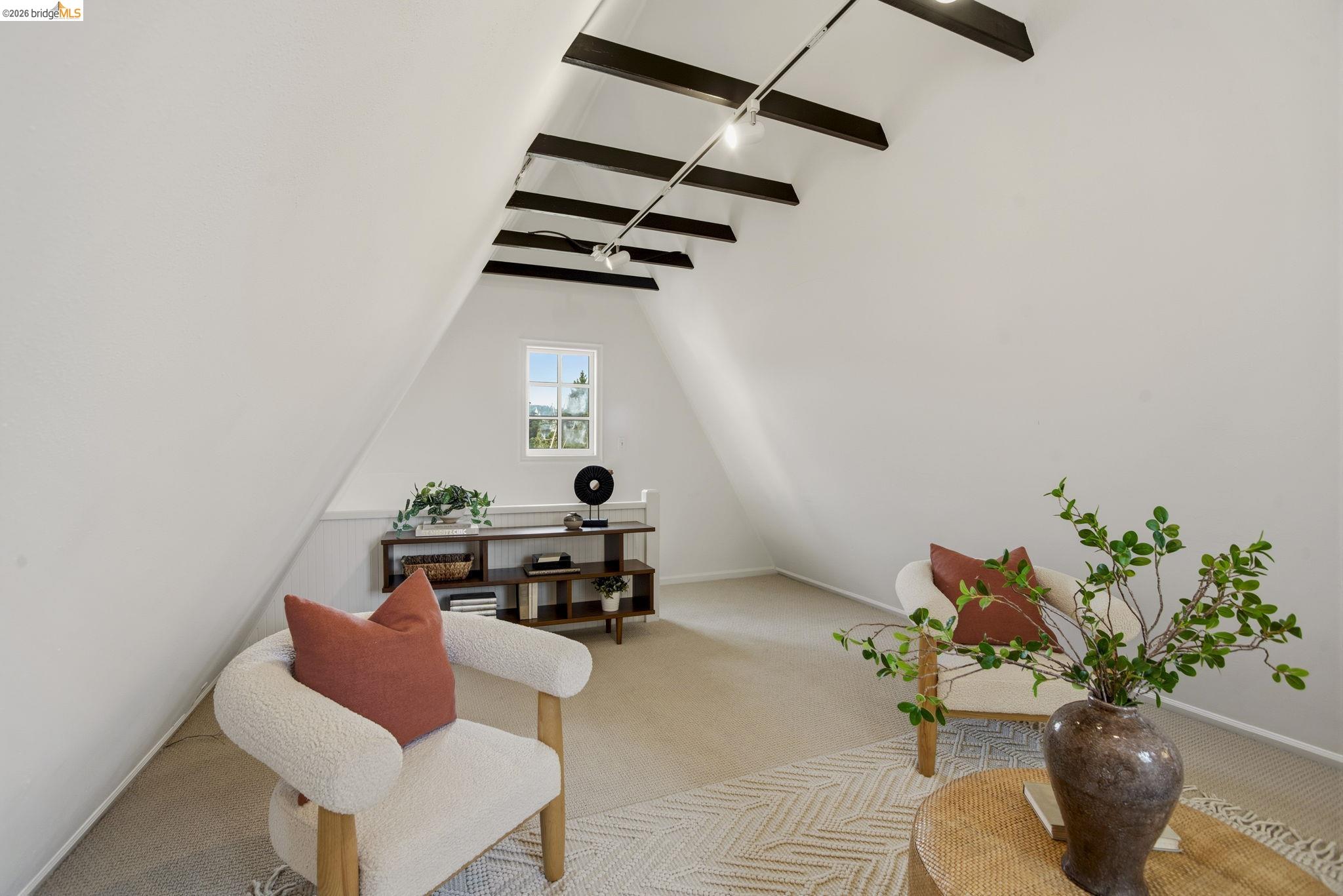 1087 Hubert Road Oakland, CA 94610 - Photo 39 of 67 Sloped ceiling featuring exposed dark wood beams and track lighting