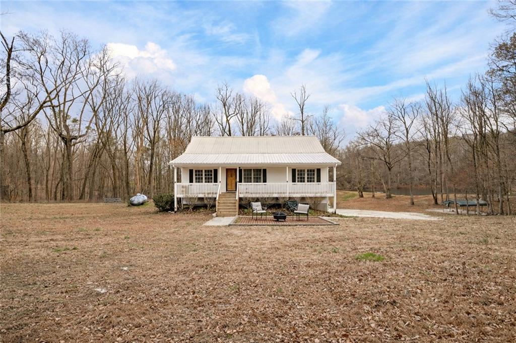 a big house with tall trees in front of it