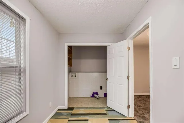a view of a big room with windows and closet