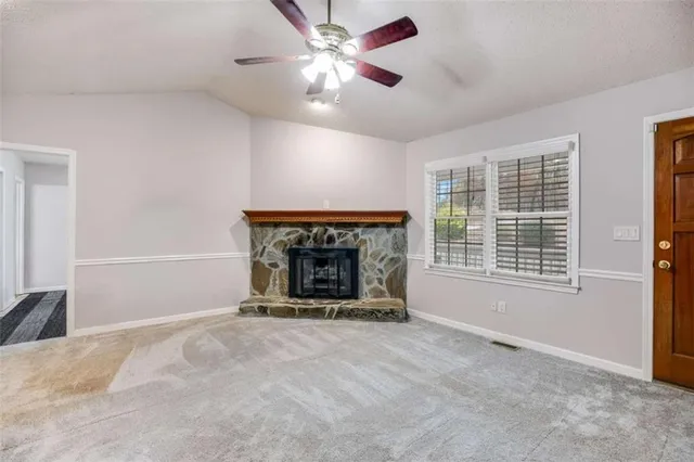 a kitchen with stainless steel appliances granite countertop wooden cabinets and a stove top oven