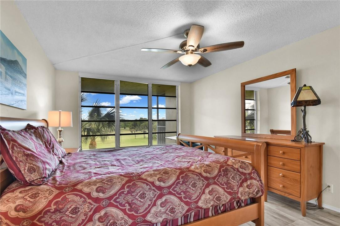 2601 South Course Drive, Unit 409 Pompano Beach, FL 33069 - Photo 11 of 58 a bedroom with a bed and two dresser