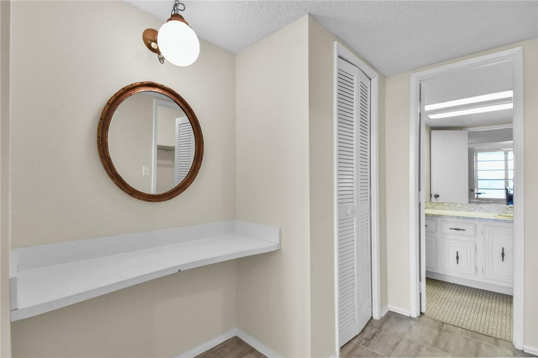 2601 South Course Drive, Unit 409 Pompano Beach, FL 33069 - Photo 13 of 58 a bathroom with a sink a mirror and a vanity