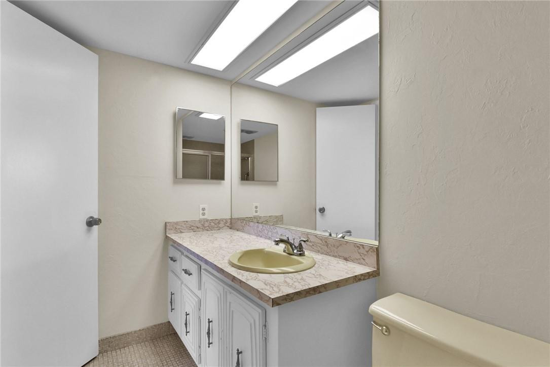 2601 South Course Drive, Unit 409 Pompano Beach, FL 33069 - Photo 14 of 58 a bathroom with a granite countertop sink and a toilet