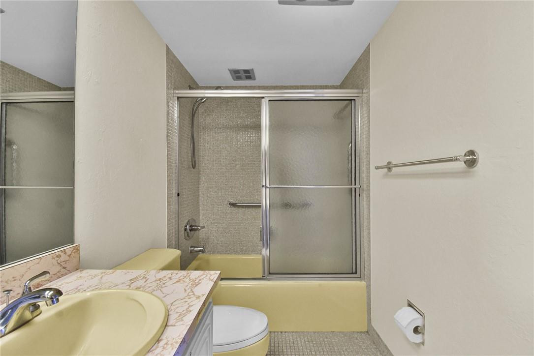 2601 South Course Drive, Unit 409 Pompano Beach, FL 33069 - Photo 16 of 58 a bathroom with a granite countertop sink toilet and shower