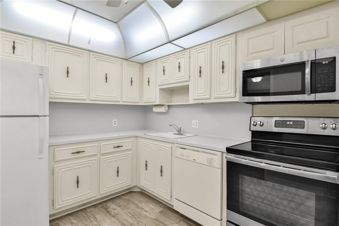 2601 South Course Drive, Unit 409 Pompano Beach, FL 33069 - Photo 20 of 58 a kitchen with stainless steel appliances granite countertop a sink and a stove