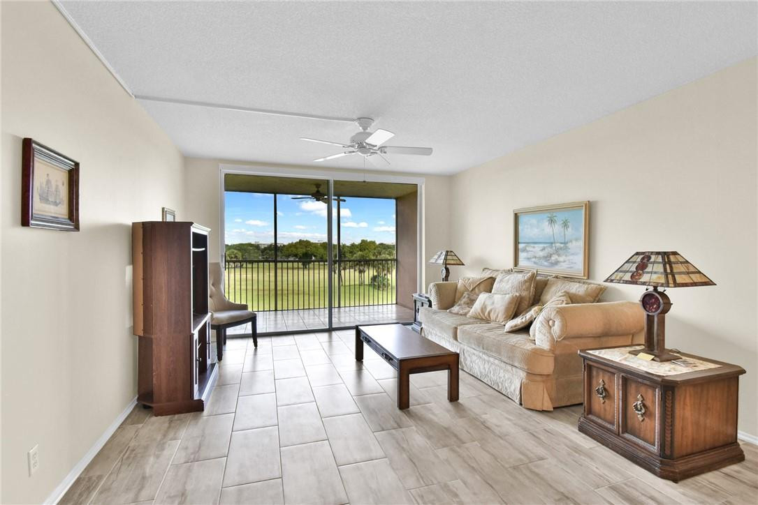 2601 South Course Drive, Unit 409 Pompano Beach, FL 33069 - Photo 3 of 58 a living room with furniture and a flat screen tv