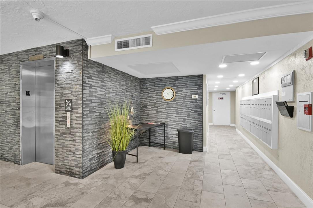 2601 South Course Drive, Unit 409 Pompano Beach, FL 33069 - Photo 31 of 58 a view of a hallway with seating area