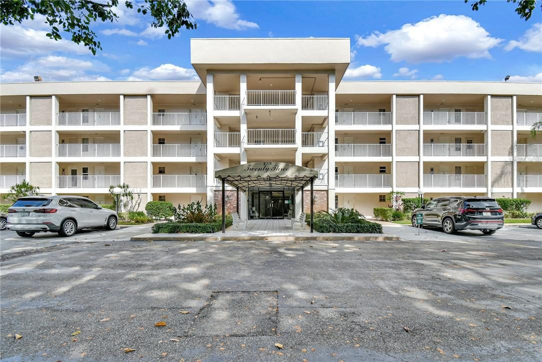 2601 South Course Drive, Unit 409 Pompano Beach, FL 33069 - Photo 41 of 58 a view of a blue house with outdoor space