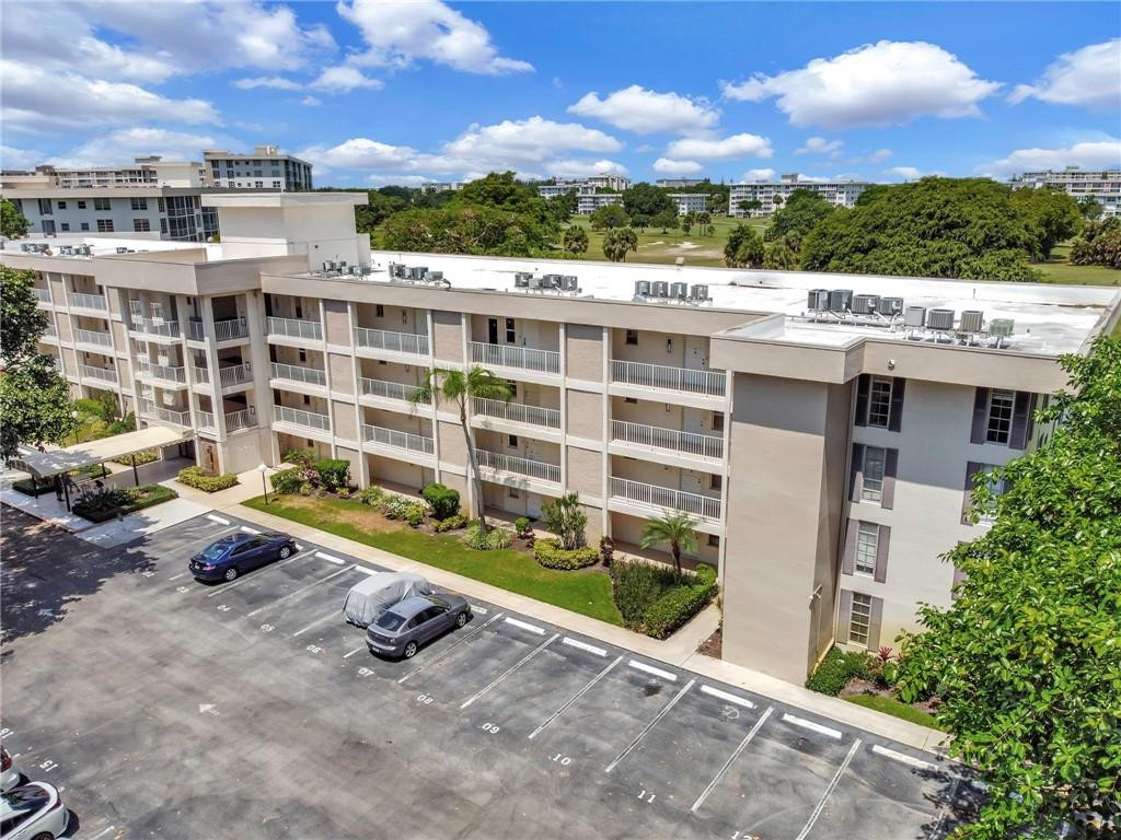 2601 South Course Drive, Unit 409 Pompano Beach, FL 33069 - Photo 43 of 58 a view of a terrace with sitting area