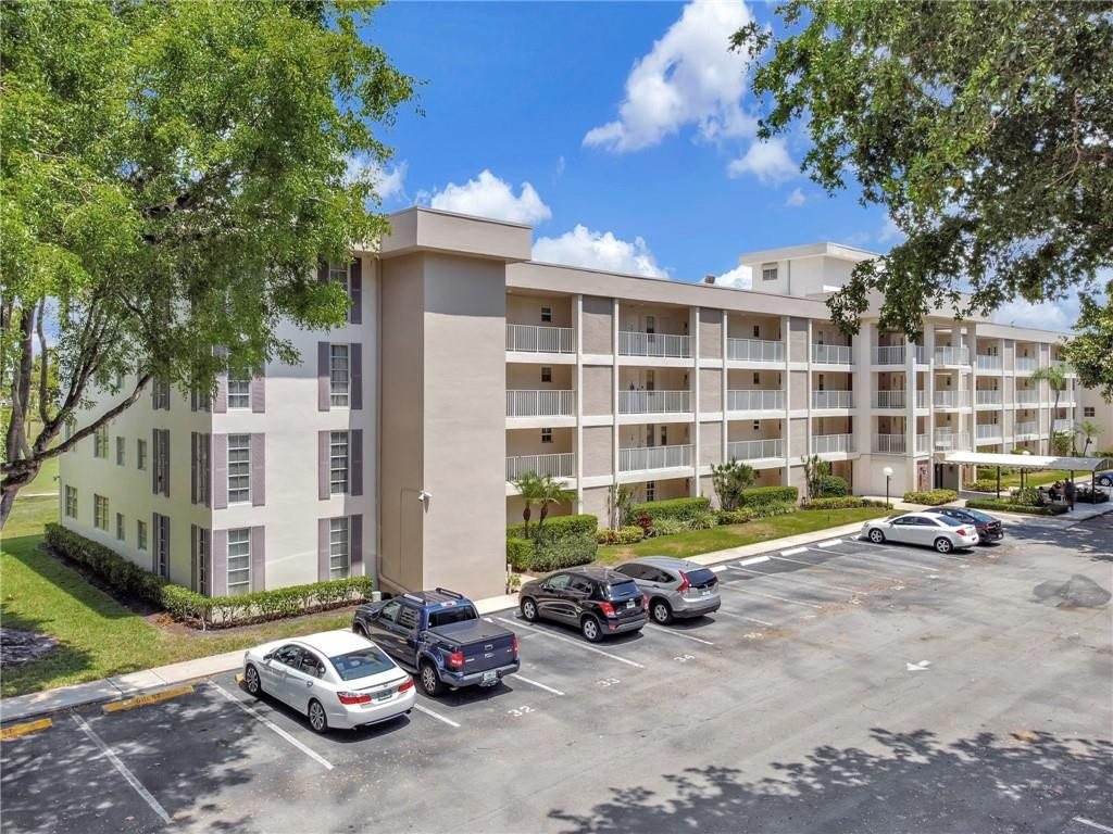 2601 South Course Drive, Unit 409 Pompano Beach, FL 33069 - Photo 44 of 58 a view of a street with cars parked