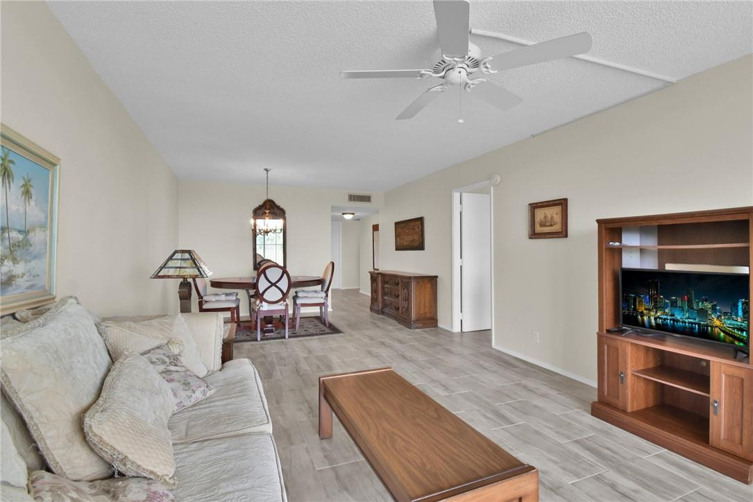 2601 South Course Drive, Unit 409 Pompano Beach, FL 33069 - Photo 5 of 58 a living room with furniture and a fireplace