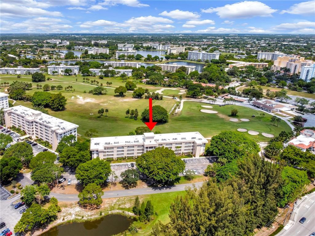 2601 South Course Drive, Unit 409 Pompano Beach, FL 33069 - Photo 53 of 58 an aerial view of residential houses with outdoor space