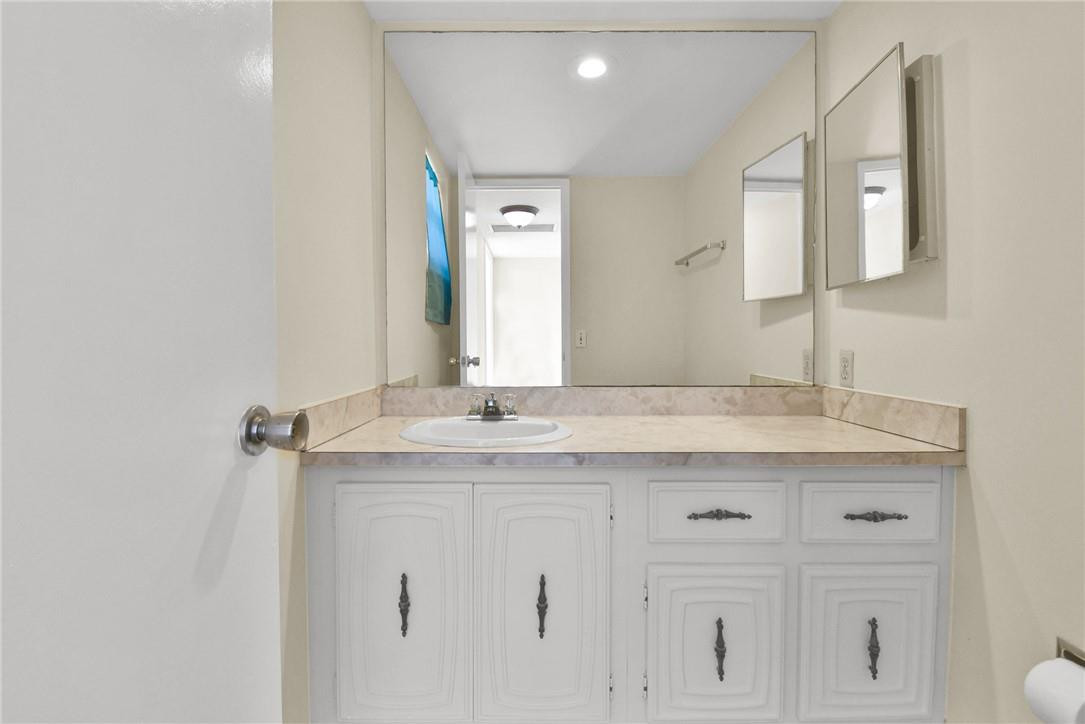 2601 South Course Drive, Unit 409 Pompano Beach, FL 33069 - Photo 8 of 58 a bathroom with a granite countertop sink and a mirror