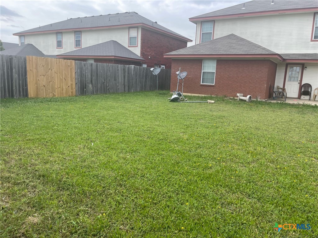 2712 Vernice Loop, Unit B Killeen, TX 76549 - Photo 27 of 30 a front view of a house with a yard and garage