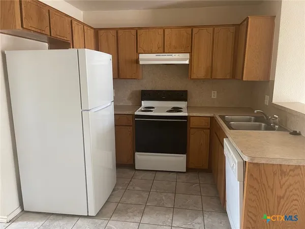 a utility room with cabinets washer and dryer