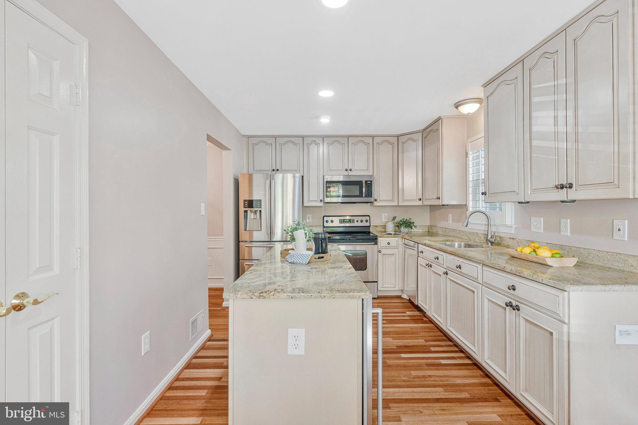 2043 Pieris Court Vienna, VA 22182 - Photo 11 of 43 a kitchen with stainless steel appliances granite countertop a sink and dishwasher a refrigerator with wooden cabinets