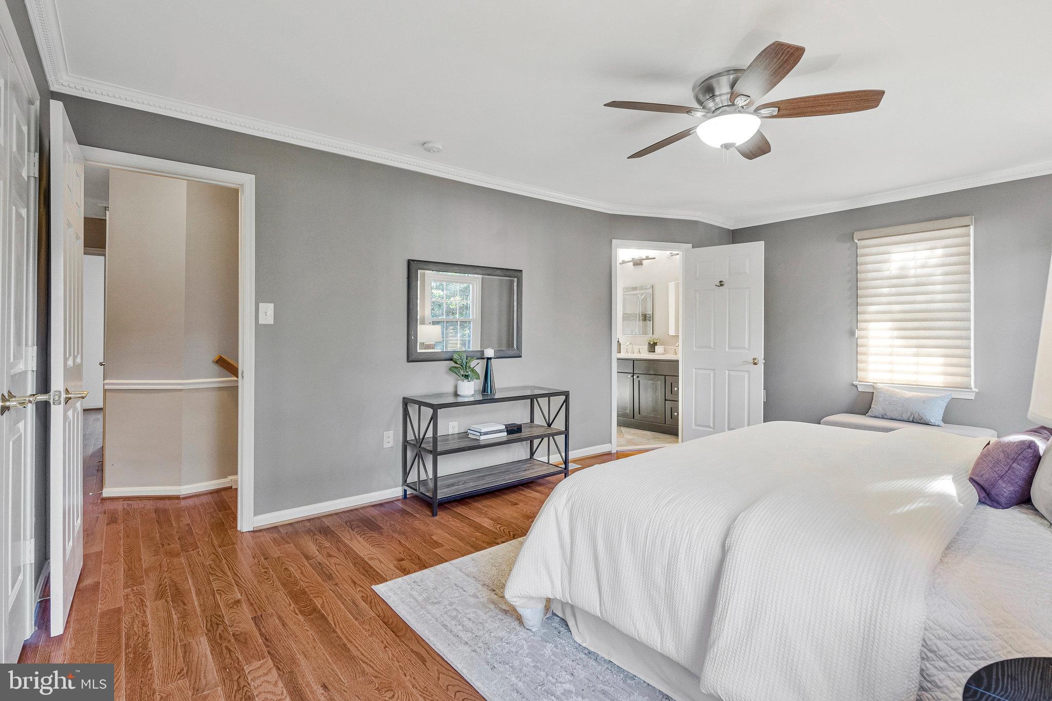 2043 Pieris Court Vienna, VA 22182 - Photo 16 of 43 a bedroom with a bed and a chandelier