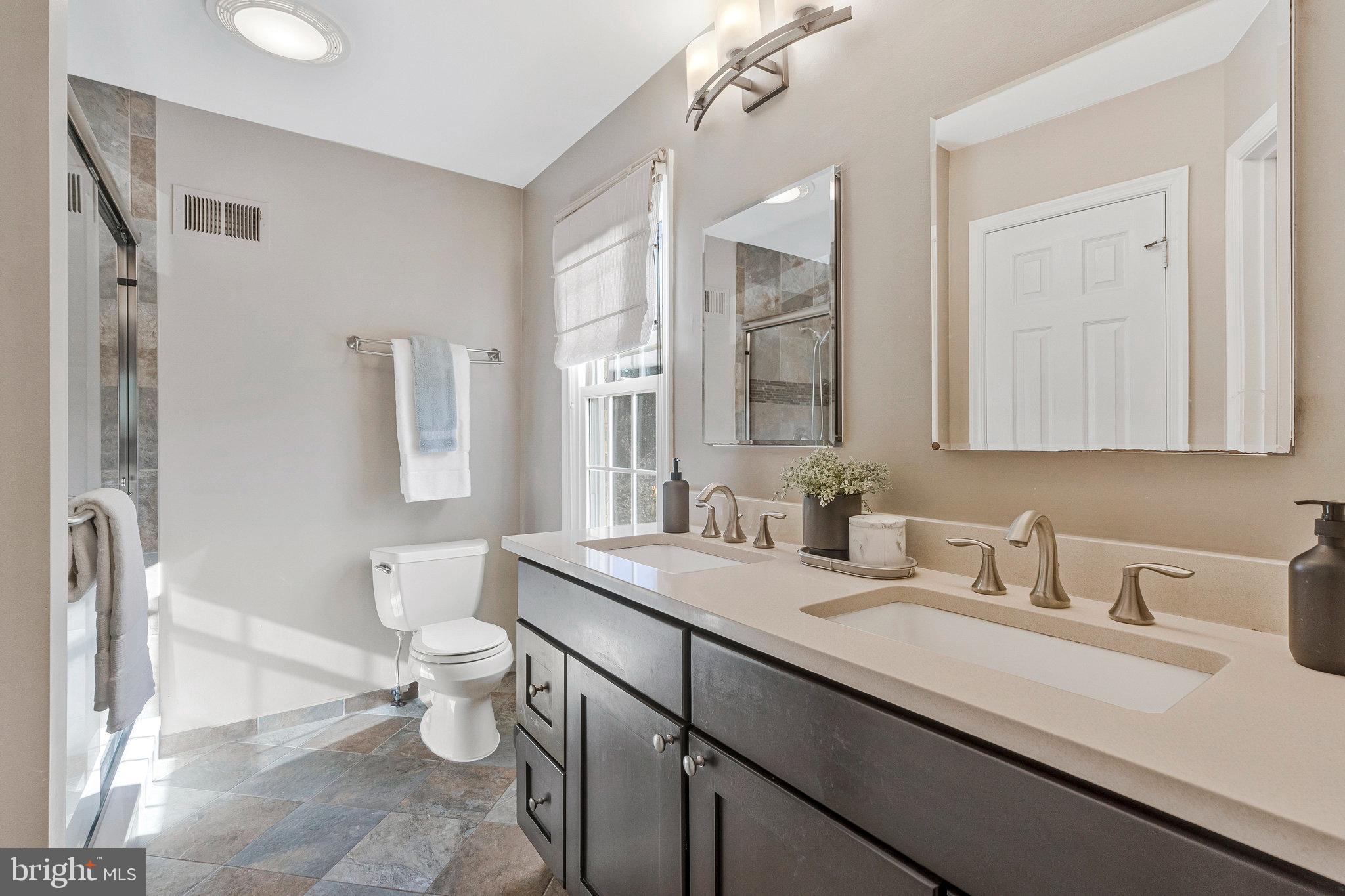 2043 Pieris Court Vienna, VA 22182 - Photo 18 of 43 a bathroom with a sink a toilet and a mirror