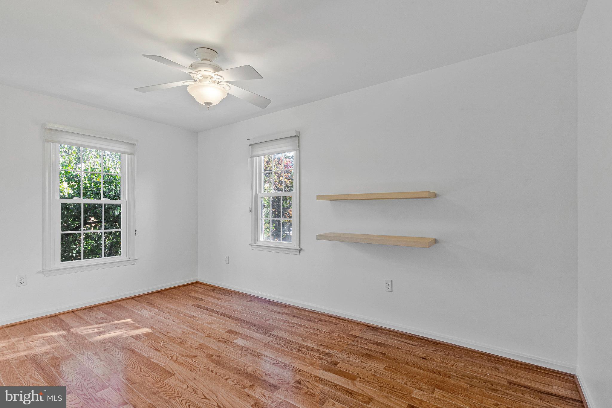 2043 Pieris Court Vienna, VA 22182 - Photo 22 of 43 a view of an empty room with a window and wooden floor