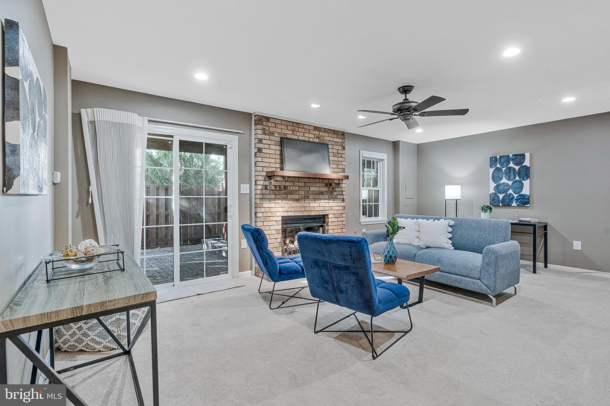 2043 Pieris Court Vienna, VA 22182 - Photo 28 of 43 a living room with furniture a fireplace and a floor to ceiling window