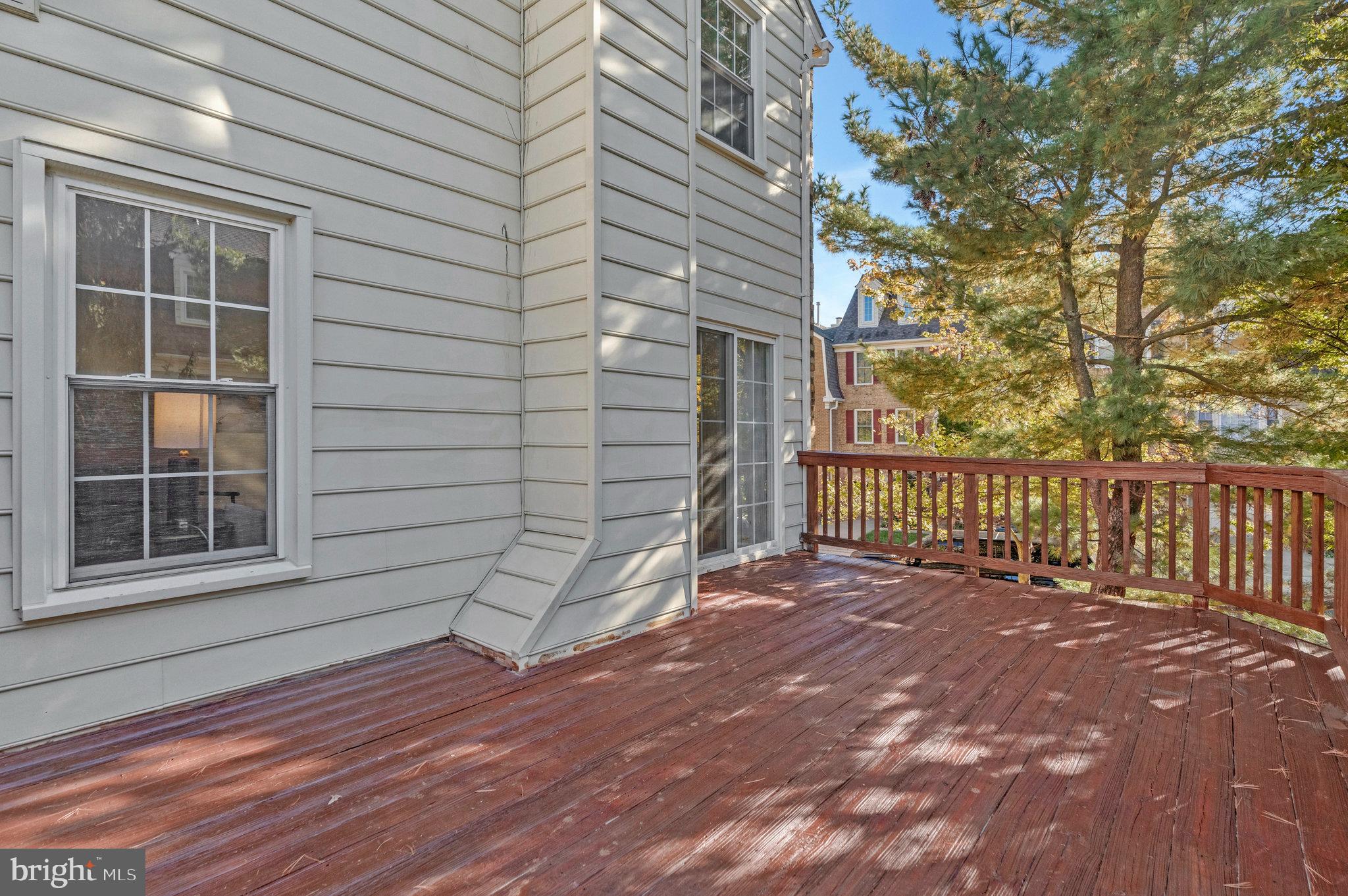 2043 Pieris Court Vienna, VA 22182 - Photo 33 of 43 a view of a house with a large window and wooden fence