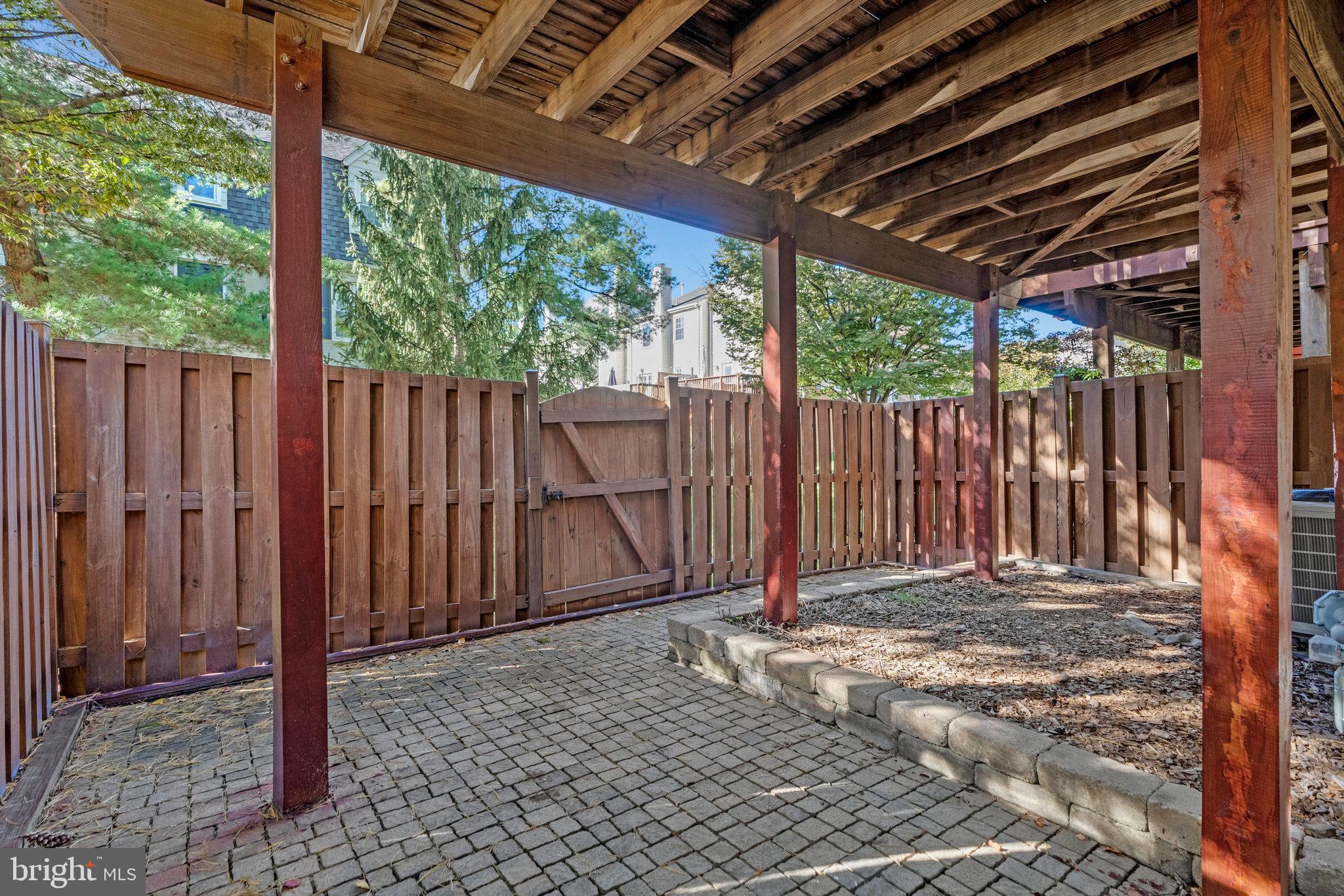 2043 Pieris Court Vienna, VA 22182 - Photo 36 of 43 a view of a backyard with wooden fence and a large tree