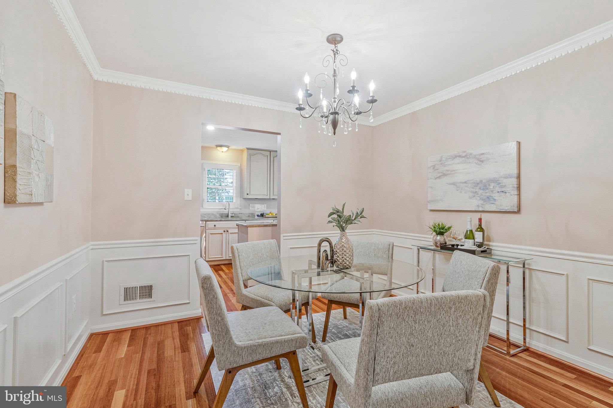 2043 Pieris Court Vienna, VA 22182 - Photo 6 of 43 a dining room with furniture a chandelier and wooden floor