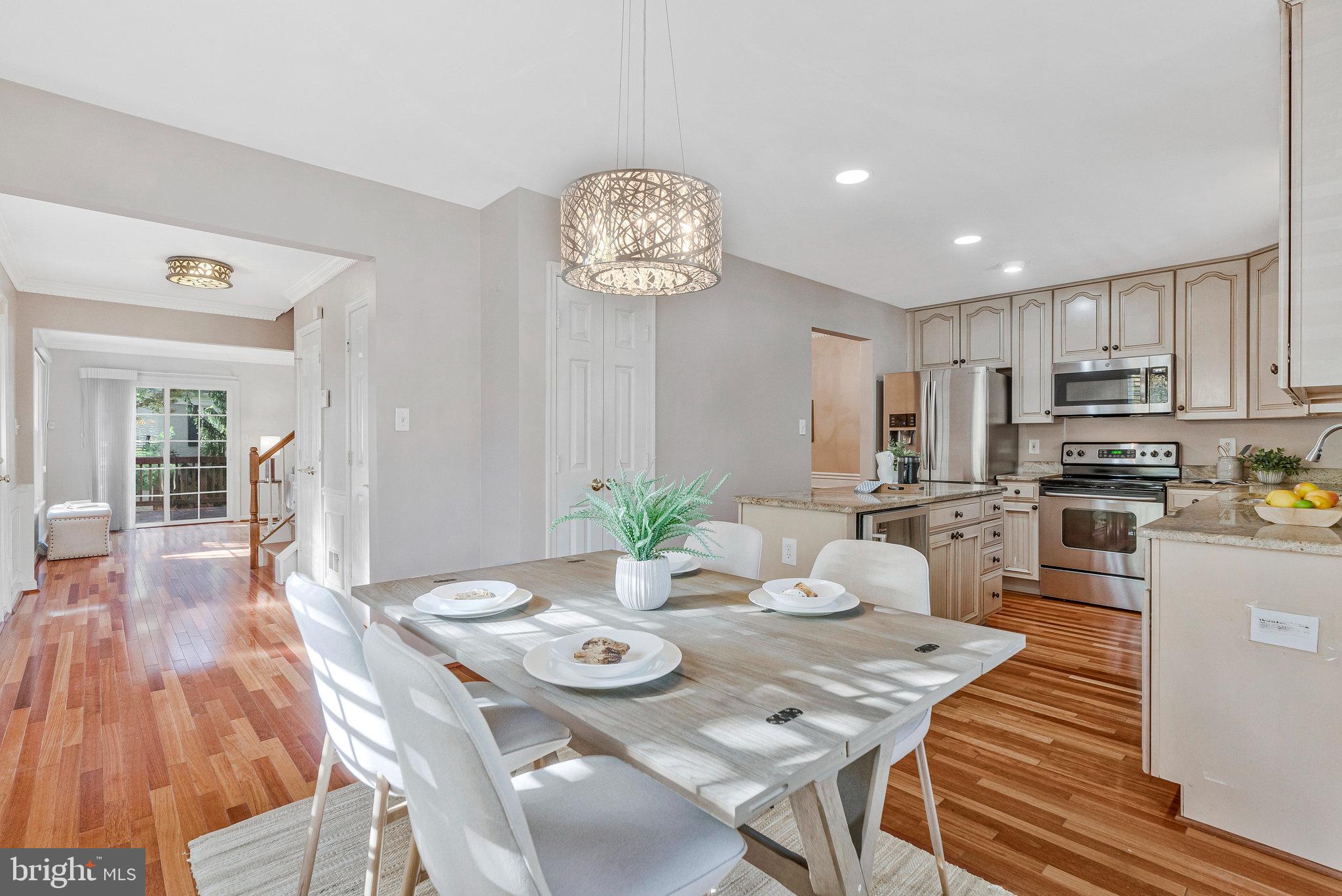 2043 Pieris Court Vienna, VA 22182 - Photo 10 of 43 a view of a dining room with furniture a kitchen and chandelier