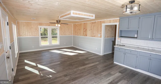 a kitchen with a wooden floor and window