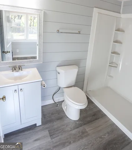 a white toilet sitting next to a bathroom sink