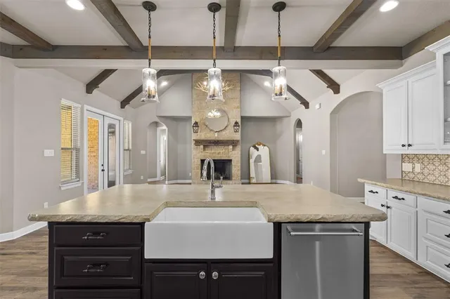 a kitchen with a counter space a sink and cabinets