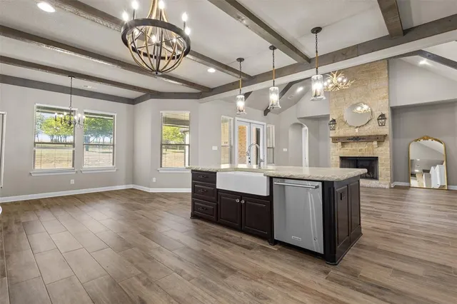 a bathroom with a granite countertop sink a toilet and shower