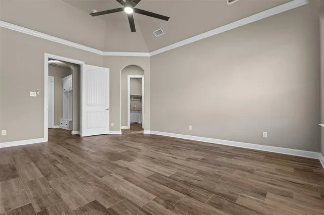 a large room with fireplace cabinet and a chandelier