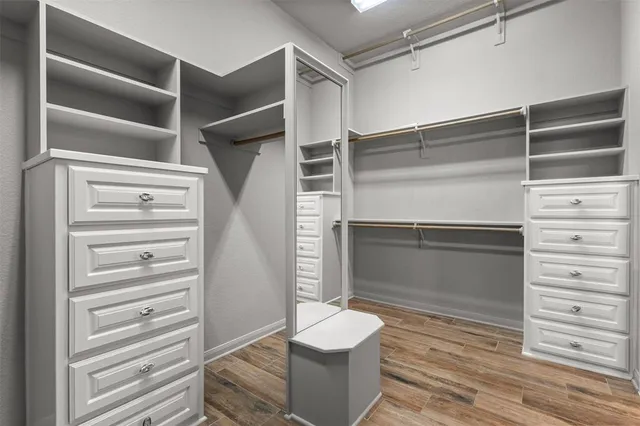 a bathroom with a double vanity sink a mirror a bathtub and shower