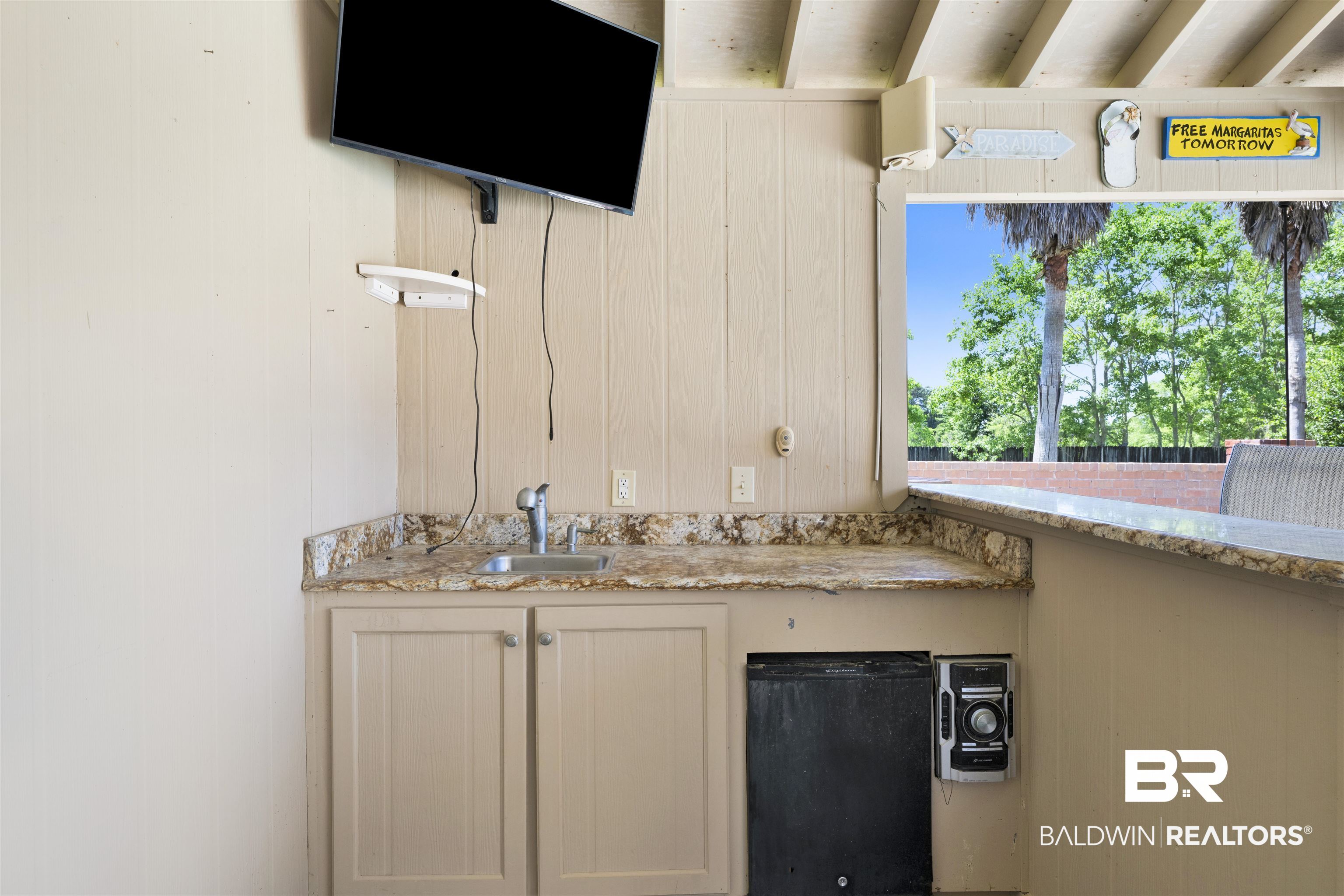 12944 Anna's Way Stapleton, AL 36578 - Photo 27 of 64 Outdoor bar area featuring a built-in sink, stone-finish countertops, lower cabinetry, and an integrated beverage cooler