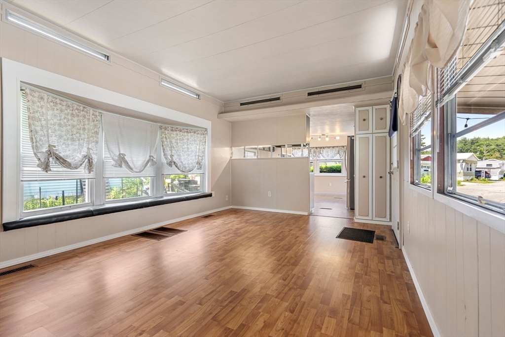 8 F Street Merrimac, MA 01860 - Photo 11 of 20 a view of empty room with wooden floor and fan