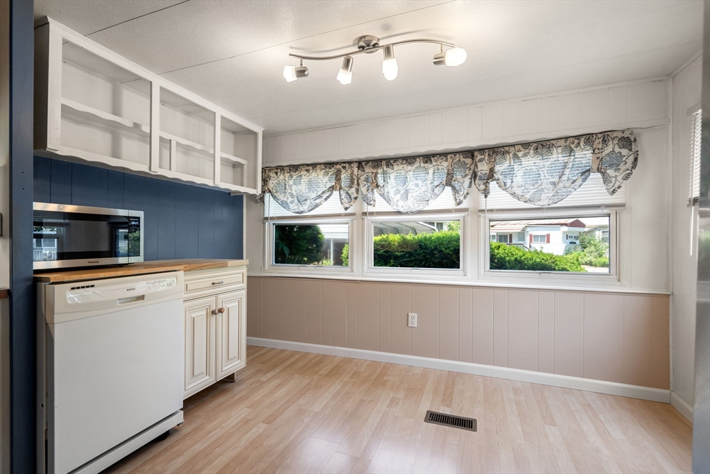 8 F Street Merrimac, MA 01860 - Photo 7 of 20 a kitchen with stainless steel appliances wooden floor and window