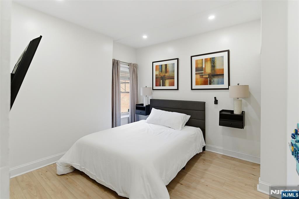 22 8th Avenue Newark, NJ 07104 - Photo 17 of 26 a bedroom with a large bed and a painting on the wall