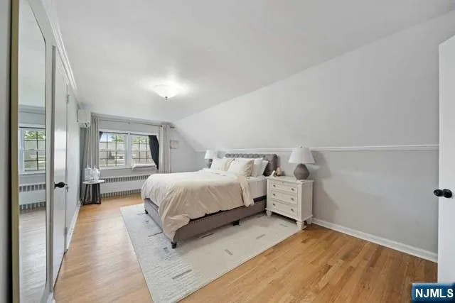 a spacious bedroom with a bed and glass door