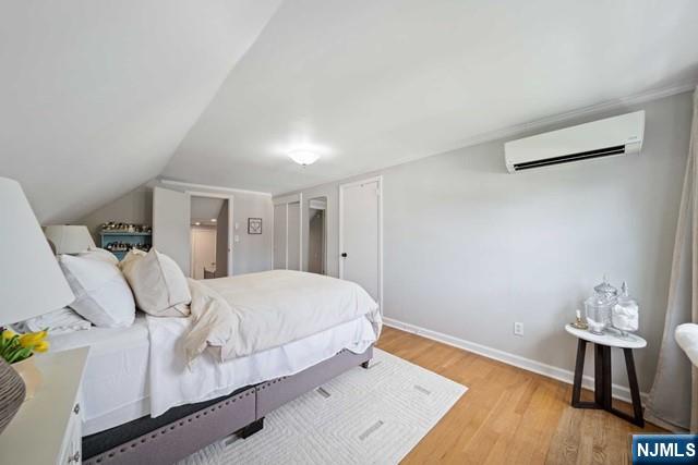 364 Rutland Avenue Teaneck, NJ 07666 - Photo 14 of 29 a bedroom with a bed and wooden floor