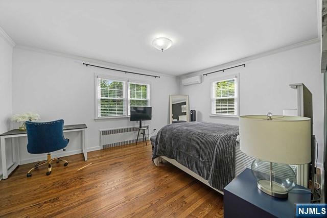 364 Rutland Avenue Teaneck, NJ 07666 - Photo 22 of 29 a bedroom with a bed a table and chair