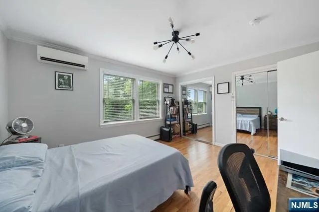 a bedroom with a bed a large window and book self