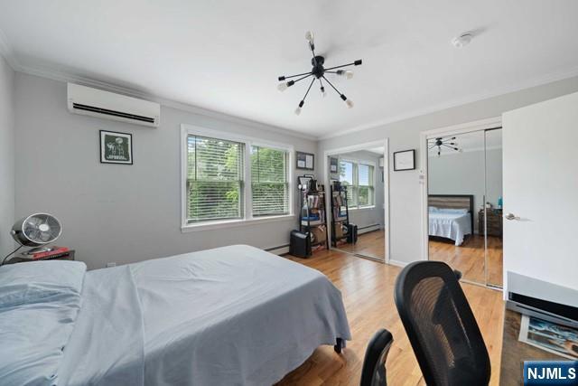 364 Rutland Avenue Teaneck, NJ 07666 - Photo 24 of 29 a bedroom with a bed a large window and book self