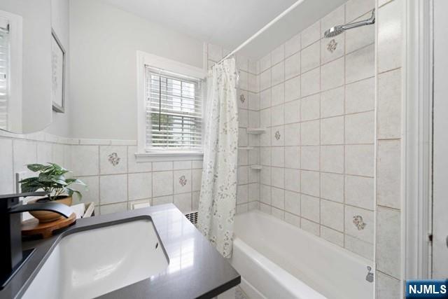 364 Rutland Avenue Teaneck, NJ 07666 - Photo 26 of 29 a bathroom with a tub a sink and a shower