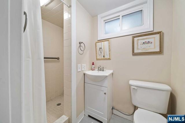 364 Rutland Avenue Teaneck, NJ 07666 - Photo 28 of 29 a white toilet sitting next to a bathroom sink