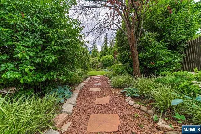 a view of a pathway both side of yard