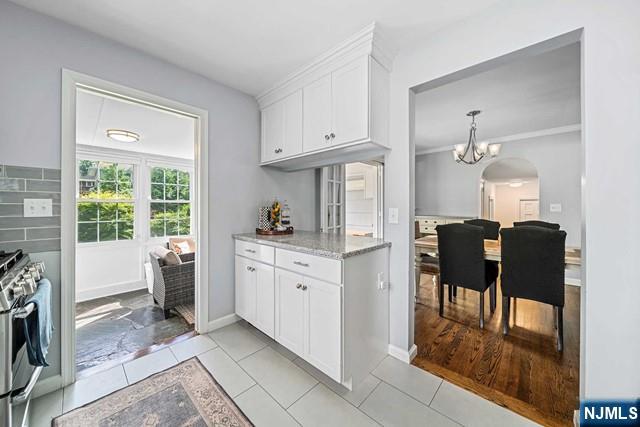 364 Rutland Avenue Teaneck, NJ 07666 - Photo 5 of 29 a kitchen with white cabinets and dining table