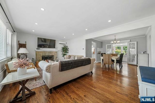 364 Rutland Avenue Teaneck, NJ 07666 - Photo 7 of 29 a living room with furniture a fireplace and a flat screen tv