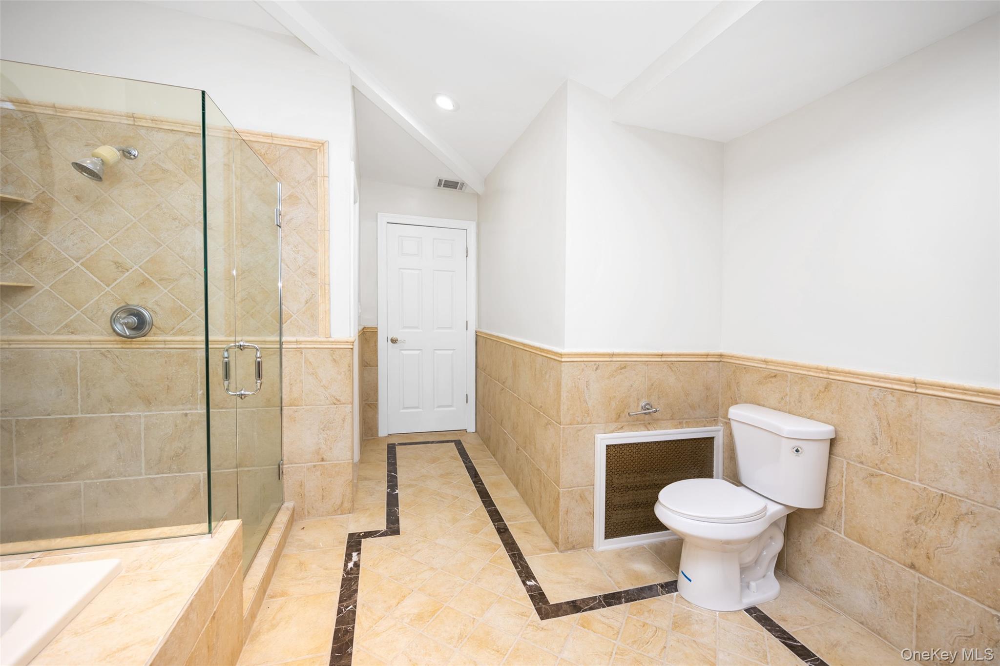 36 Red Spring Lane Glen Cove, NY 11542 - Photo 14 of 33 Primary bathroom (angle 3) – Bright and airy with vaulted ceilings and accent lighting, combining comfort and sophisticated style.